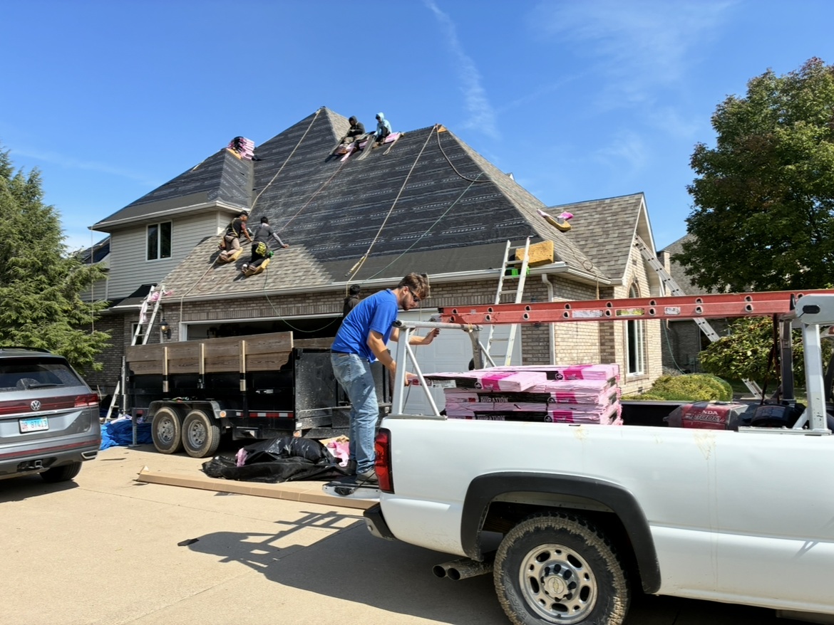 Milo's crew installing the new roof with underlayment and shingles in progress