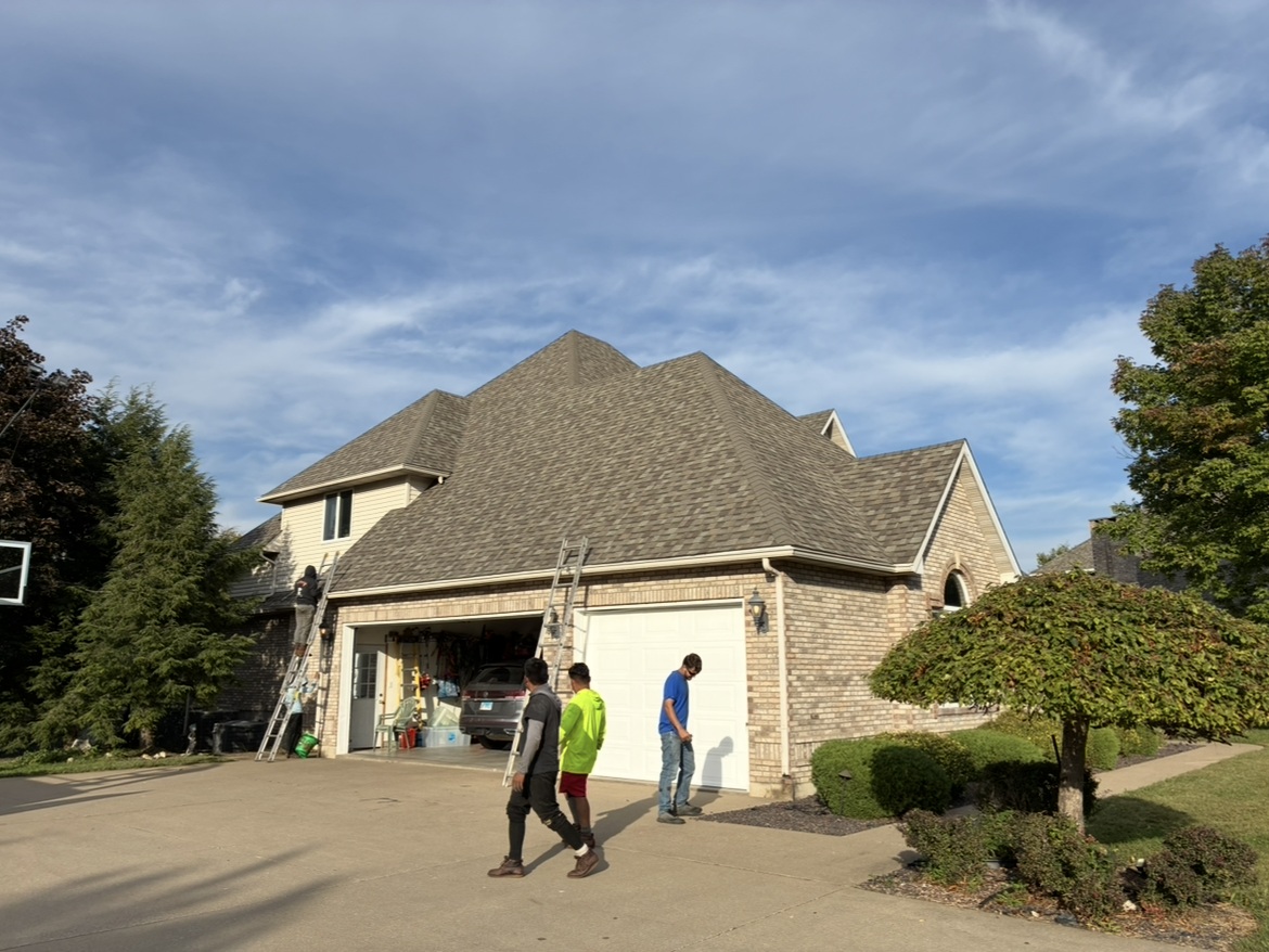 Finished shingle roof on a large two-story brick home, a recent Milo's Roofing & Concrete project